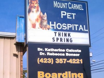 a sign for mount carmel pet hospital in front of a building a sign for mount carmel pet hospital in front of a building